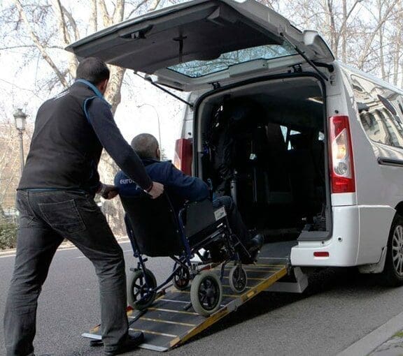 person in wheelchair on car ramp - Accessible Parking Permit in Israel